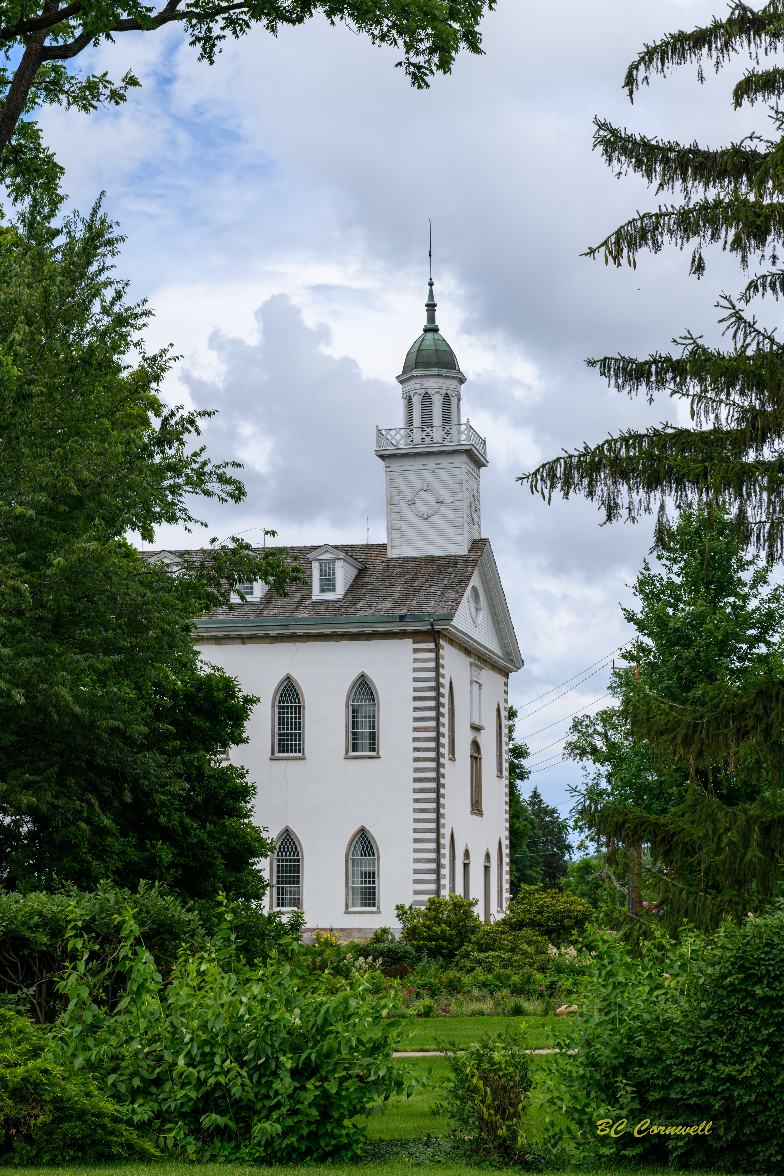 The Kirtland Temple framed by trees and gardens